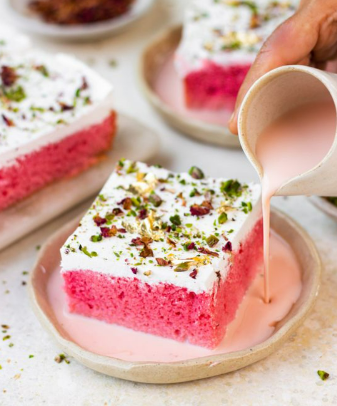 Rose milk cake topped with dry fruits and rose petals