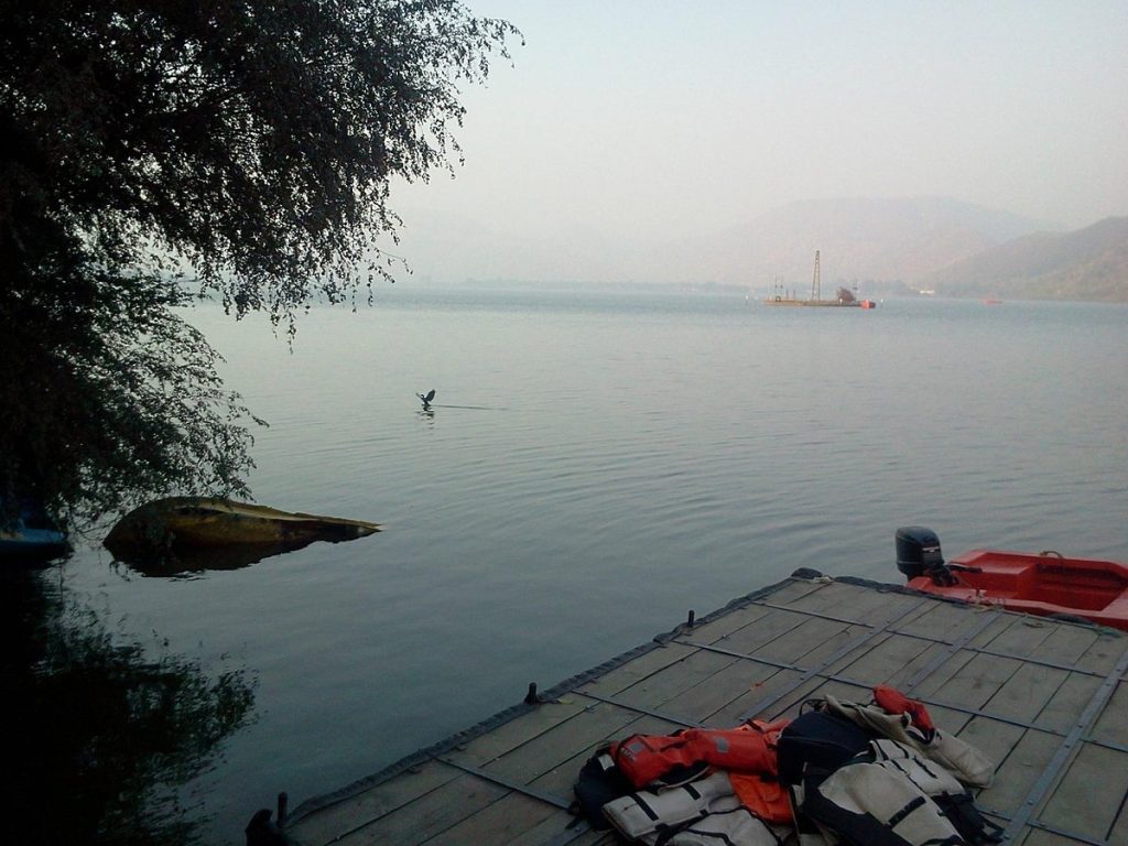Calm Silchar River surrounded by hills and trees