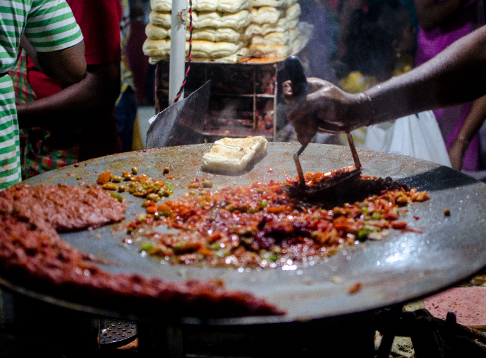 Pav bhaji being made in a pan
